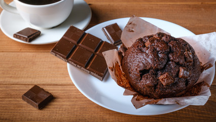 Chocolate muffin, Chocolate and cup of black coffee on the table.