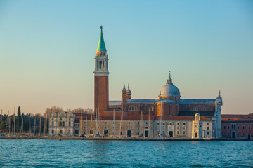 Fototapeta na wymiar High bell tower and the Church of Saint George called San Giorgio Maggiore in Venice. Italy.