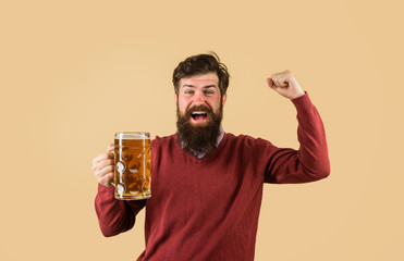 Bearded male tasting fresh brewed beer. Craft beer at restaurant. Drink, alcohol, leisure and people concept. Oktoberfest festival. Beer in Germany. Bearded man drinking beer from glass at bar or pub.