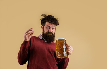 Oktoberfest festival. Alcohol. Bearded drunk man holds glass with beer. Oktober fest. Tasting fresh brewed beer. Brewer hold glass of craft beer. Brewery concept. Man with beer of mug. Barman. Brewer.