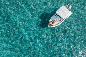Aerial view of a young couple enjoying a sunny day on the boat