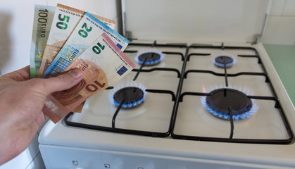 Energy efficiency concept with gas cooker and euro currency – the cost of natural gas is more...