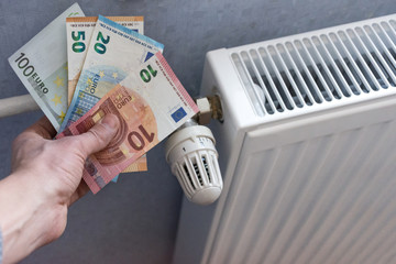 Energy efficiency concept with radiator and euro currency – the cost of thermal energy is more...