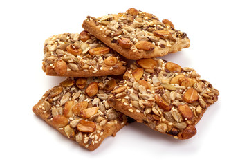 Cookies with nuts and seeds of peanut, sunflower seeds, sesame, linen, bio organic food, isolated on white background