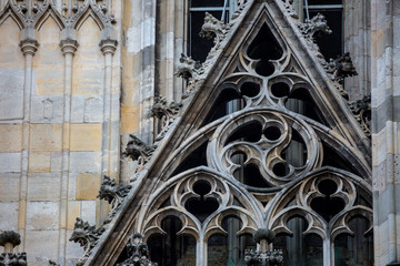 Elements of Gothic architecture. Gable wall rose(rosette) windows on the facade. Pinnacles, crabbs and other chiseled stone of an ancient medieval cathedral. St. Stephen's Cathedral. Vienna. Austria