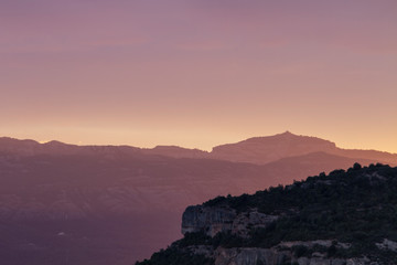 Sunset in the mountains with pink sky.