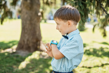 Little boy talking on smart watch with mother.