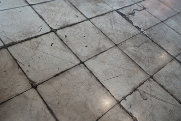 Old dirty grunge tile floor with reflected from light bulb