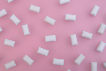 Texture of white chewing gum on a pink background. Close up. Flat lay