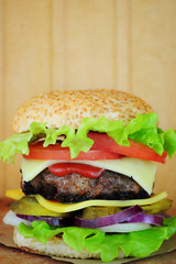 Juicy burger on a wooden background