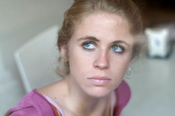 Young blonde girl photographed in the cloister of an old building