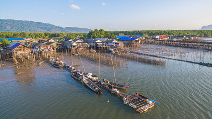 Fototapeta na wymiar during low tide fishing boats stuck on the mud in Ban Sam Chong fishing village