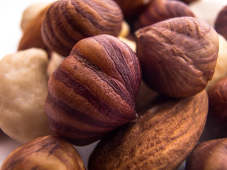 Blend of fresh healthy tasty nuts on white background