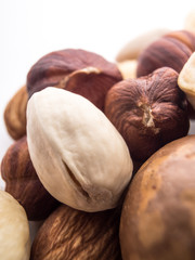 Blend of fresh healthy tasty nuts on white background