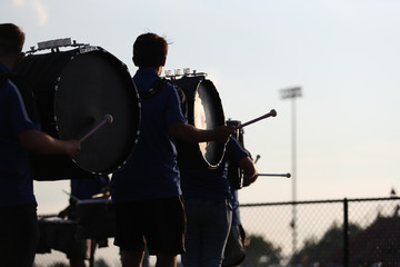 High school band members play during a high school football game.