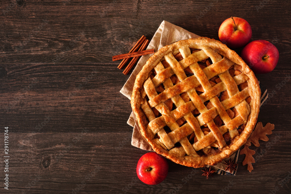 Poster homemade autumn apple pie, top view with frame of ingredients on a dark wood table with copy space