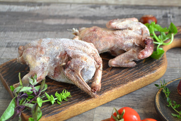Wildfowl hunting. Two raw woodcock on rustic table, russian cuisine