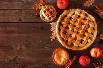 Homemade autumn apple pie corner border. Top view table scene over a rustic wood background with...