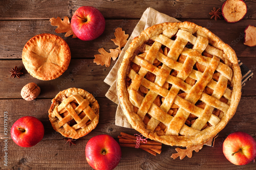 Poster homemade autumn apple pies, top view table scene with a rustic wood background