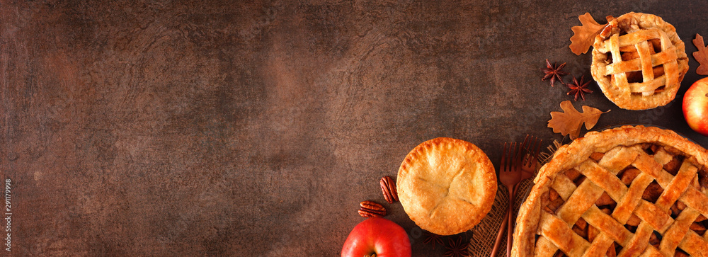 Poster Homemade autumn apple pie corner border banner. Top view over a brown stone background with copy space.