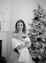 stunning black and white portrait beautiful girl like Cinderella in a Christmas fairy tale stands...