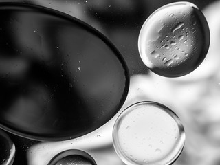 Monochrome surreal psychedelic abstract liquid background. Water and oil drops with small air...