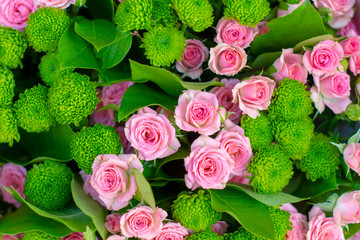 A lot of pink romantic roses in a bouquet on top for a gift and expression of feelings. Background.