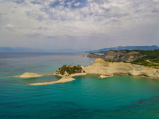 Aerial photo of iconic white rock steep cliff volcanic bay of Cape Drastis and Peroulades area with tropical deep turquoise clear sea. Photo from drone. Corfu island, Ionian, Greece