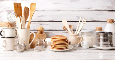 Cooking pancakes. Ingredients, crockery and kitchenware for pancakes.