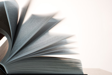 turning pages of a book in motion, paging