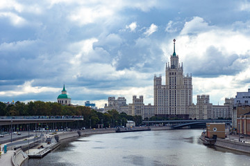 Fototapeta na wymiar View of Moscow on a cloudy day. River Moscow.High-rise building on Kotelnicheskaya embankment. Park Zaryadye. Pedestrian platform over the river. Business card of Moscow. View of the capital of Russia