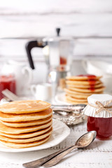Tasty breakfast. Pancakes with strawberry confiture and butter.