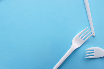 Ecological concept, zero waste. Recycling plastic forks texture on blue background. Concious consumption, environment care