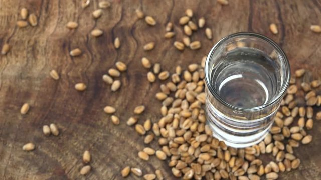 Wheat Liqueur shot on a rotating vintage plate (seamless loopable)