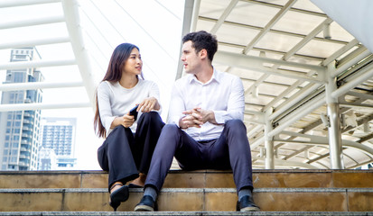 Fototapeta premium young business people sitting on step outdoor
