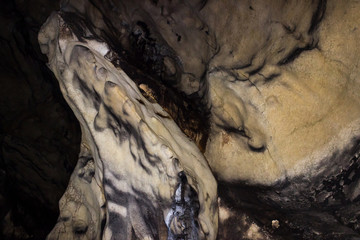 Impressive, alien shapes inside the massive cave and dark, spooky background