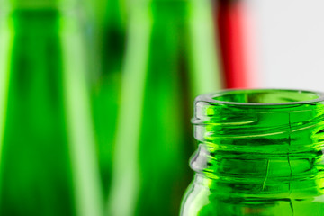 Colorful empty beer bottles, lots of empty beer bottles. Closeup, daylight. Beer's over, party's over.
