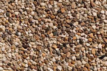 Fragment of a wall covered with fine stone close-up. Modern buil