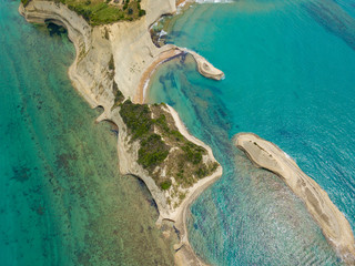 Aerial top photo of iconic white rock steep cliff volcanic bay of Cape Drastis and Peroulades area with tropical deep turquoise clear sea. Photo from drone. Corfu island, Ionian, Greece