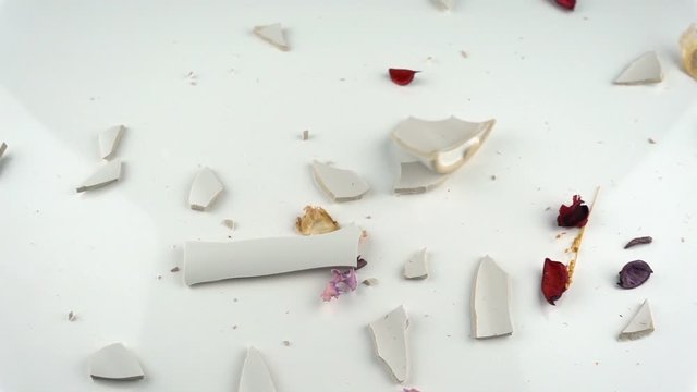 The concept of destruction. Falling and breaking decorative vase in slow motion.