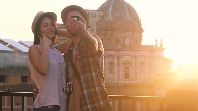 Lovely couple of tourist at Roman Forum taking selfie videos with action camera. Rome, Italy