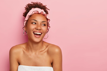 Hygiene, beauty and healthy lifestyle concept. Pretty smiling African American woman looks on right...