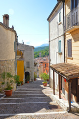 Carpinone, Italy, 09/05/2017. A narrow street among the houses of a rural village, embellished with flowers and colors.