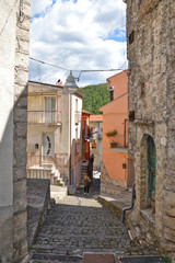 Carpinone, Italy, 09/05/2017. A narrow street among the houses of a rural village, embellished with flowers and colors.