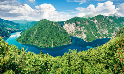 Naklejka na ściany i meble Aerial summer view of Pivsko lake. Gorgeous morning scene of canyon of Piva river, Pluzine town location, Montenegro, Europe. Beautiful world of Mediterranean countries. Traveling concept background.