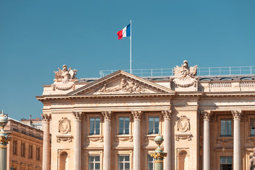 Fototapeta na wymiar French flag waving on a government building in Paris