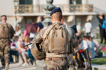 An unidentified Man in military uniform and with a military weapon patrolling the streets of the...