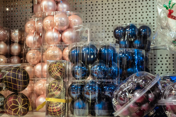 Fototapeta na wymiar Christmas balls toys on a shelf in shop market