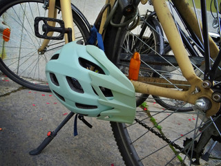 Close-up of a helmet attached to a bicycle parked in the city center