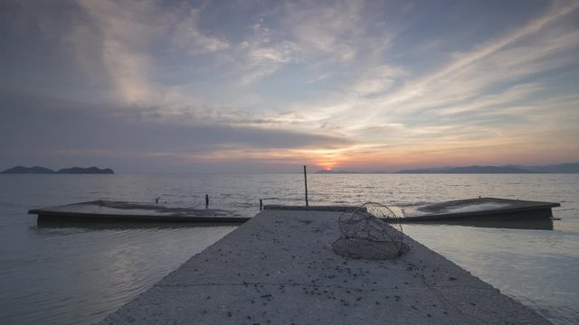 Timelapse beautiful sunset at fisherman jetty without boat at Juru, Penang, Southeast Asia.